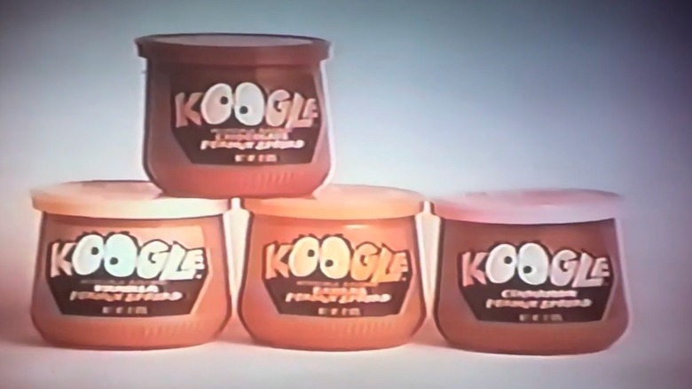 Four jars of different flavors of Kraft Koogle staged in commercial from the 1970s
