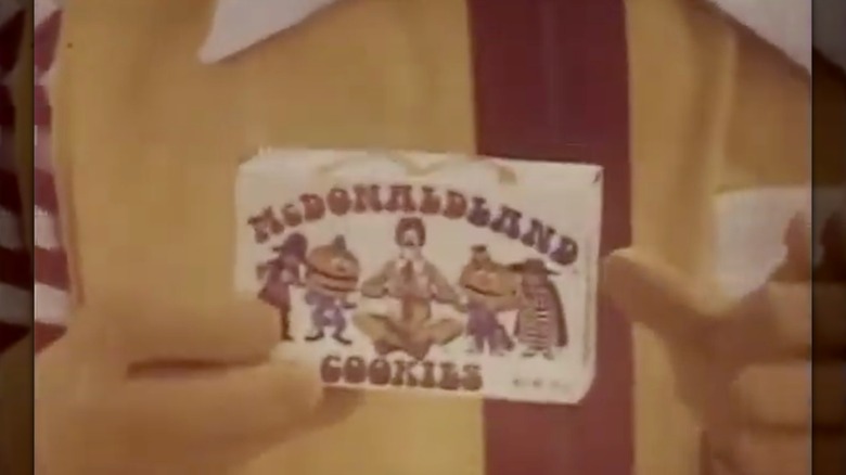 Close up of Ronald McDonald clown holding box of McDonaldland Cookies in commercial from 1970s