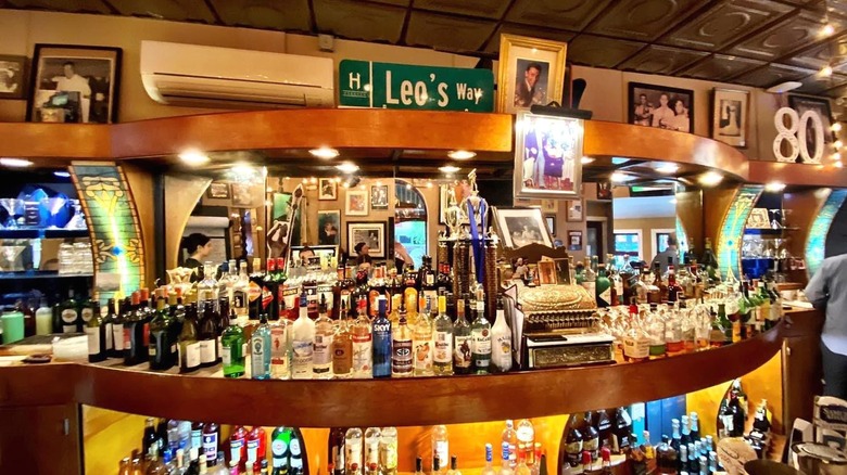 The Leo's Grandevous half-mooned bar covered with various bottles of alcohol.