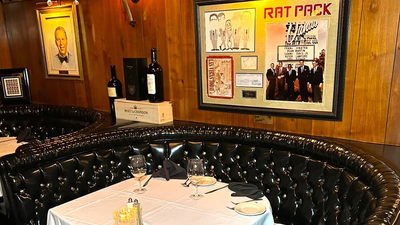 An empty table at the Golden Steer Steakhouse with Frank Sinatra and Rat Pack memorabilia on the wall