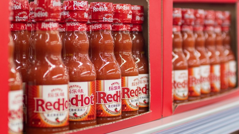 Bottles of Frank's RedHot Sauce on store shelf