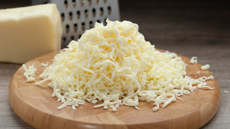 Grated mozzarella cheese on wood