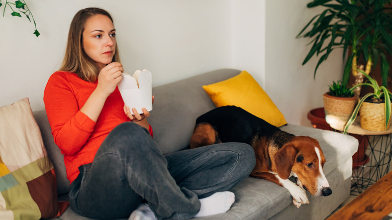 WOMAN EATING COMFORT FOOD