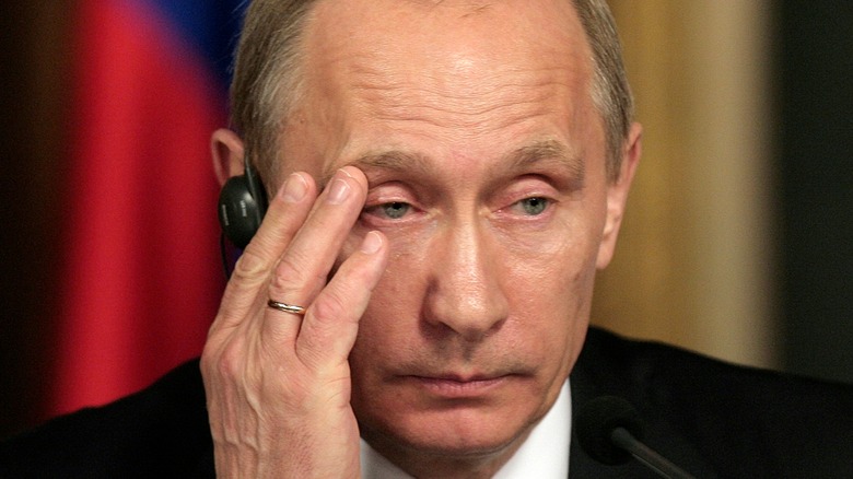 Vladimir Putin hand over cheek