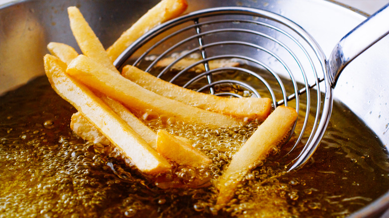 French fries being fried in oil