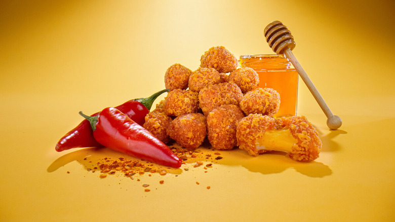 Hot honey curds piled between red chilis and honey