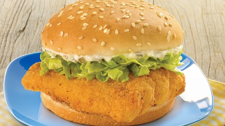 Church's fish sandwich on a blue plate