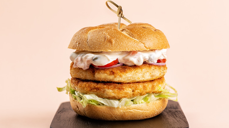 Double fillet fish sandwich on wooden board