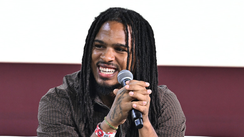 Keith Lee sitting with microphone
