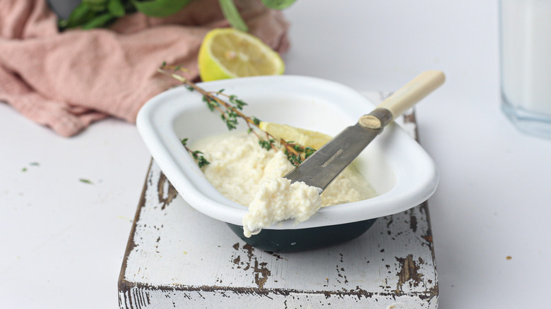 fresh ricotta in a bowl with a knife