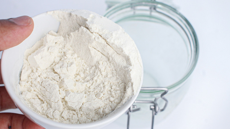 adding flour to mason jar