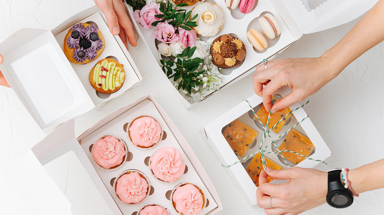 assortment of sweet treats in white boxes