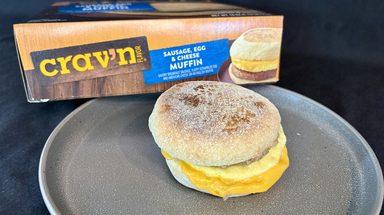 breakfast sandwich on plate in front of box