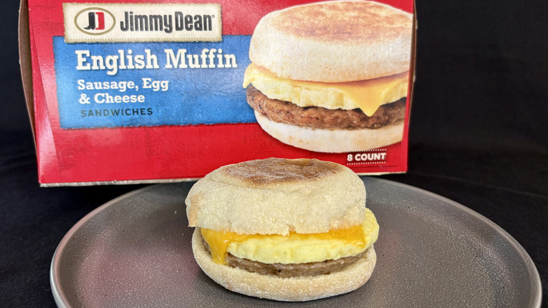breakfast sandwich on plate in front of red box