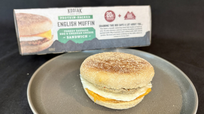 breakfast sandwich on plate in front of box