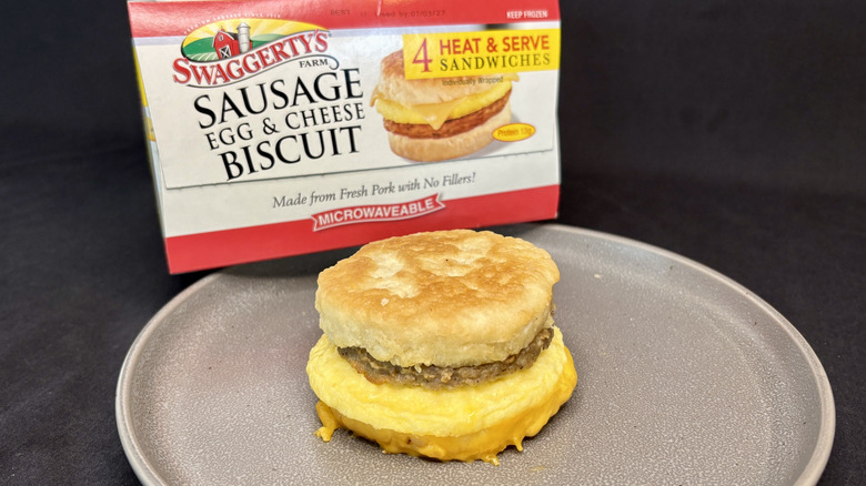 breakfast sandwich on plate in front of box