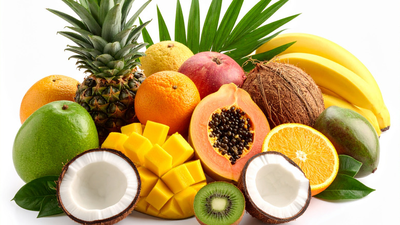 Variety of whole and split tropical fruits