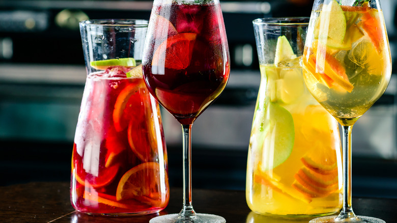 two pitchers and glasses of red and white sangria