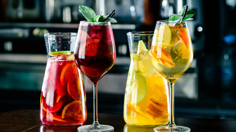 two pitchers and glasses of red and white sangria
