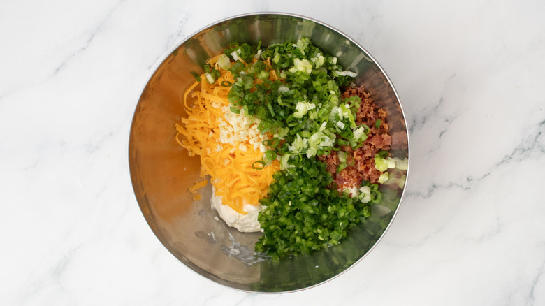 Cheese, jalapeño, scallions, and bacon in bowl