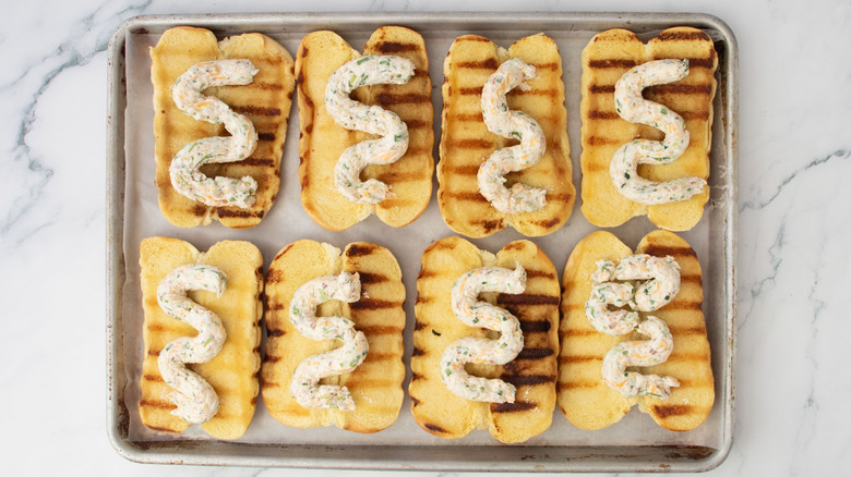 Grilled hot dog buns with cream cheese squiggles on top