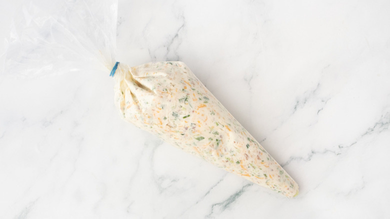 Jalapeño cream cheese mixture in piping bag