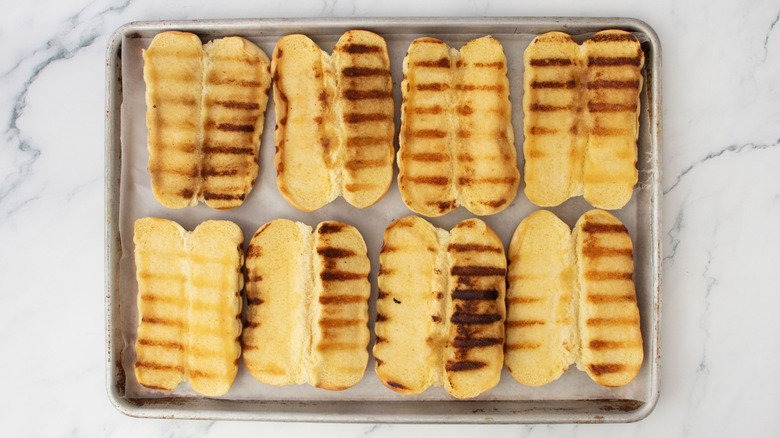 Grilled hot dog buns on sheet pan