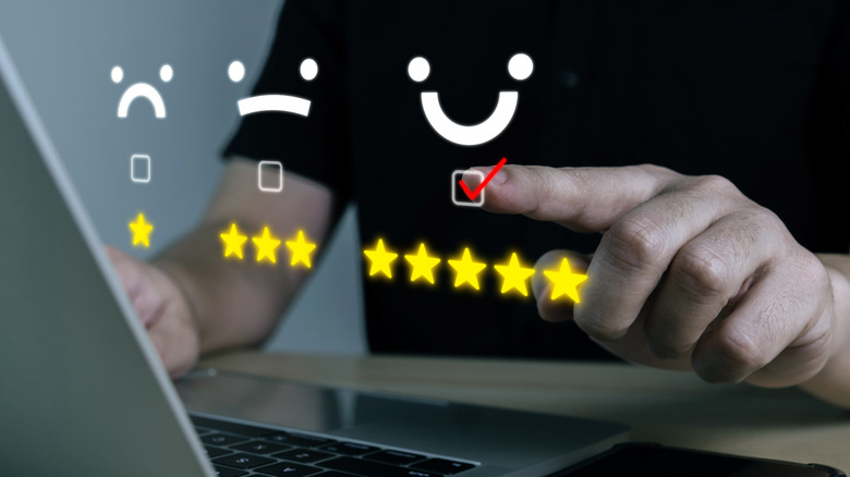 Business review graphic with a finger tapping the five-star button underneath a smiling face