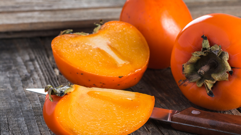 whole and sliced persimmon fruit