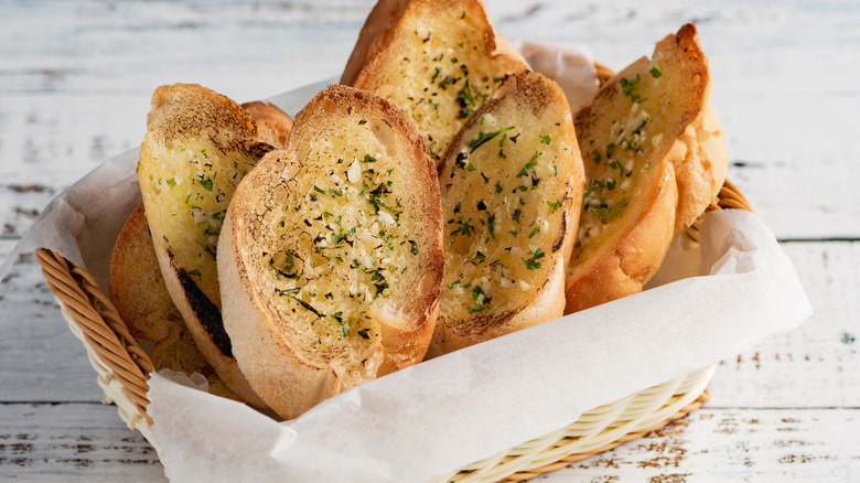 A basket filled with sliced garlic bread