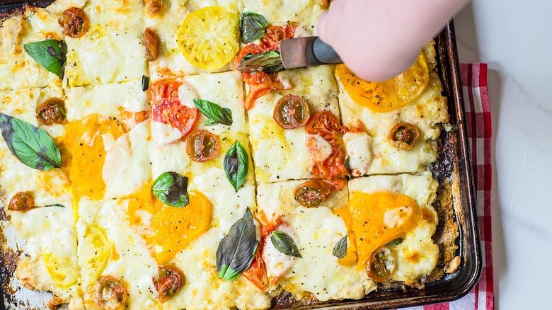 A cutter slicing pizza