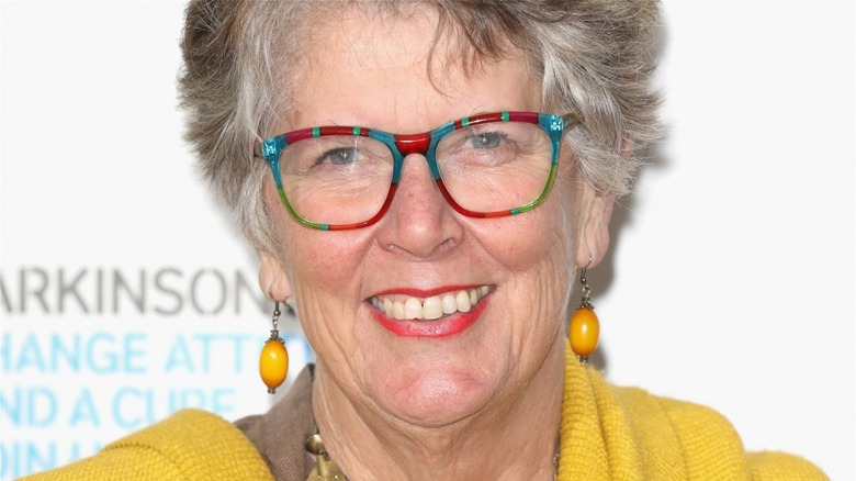 Prue Leith smiling in multi-color-rimmed glasses 