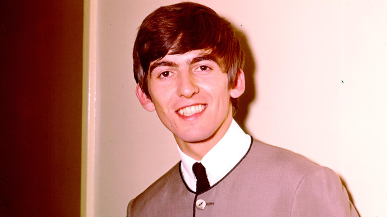 George Harrison smiling at camera.