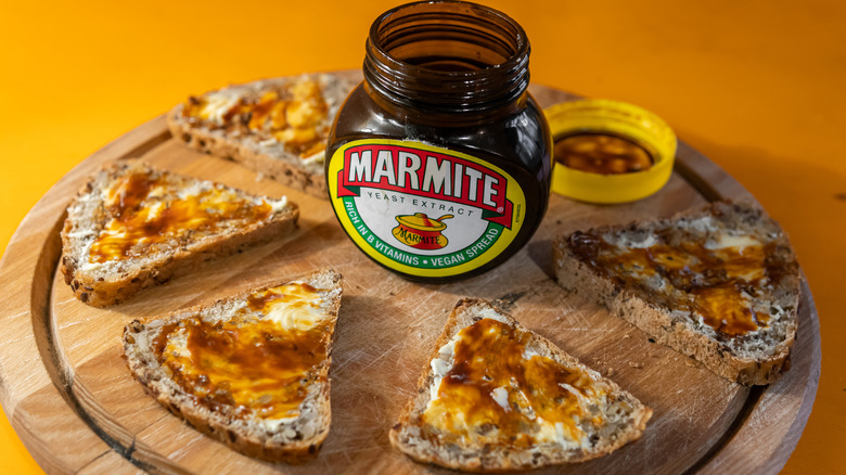 Jar of Marmite surrounded by bread slices