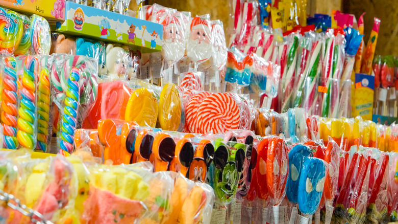 Generic, packaged, classic treats on wooden candy store shelves.
