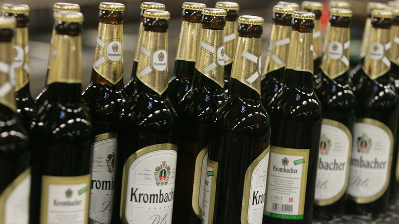 Krombacher beer bottles at a production facility.