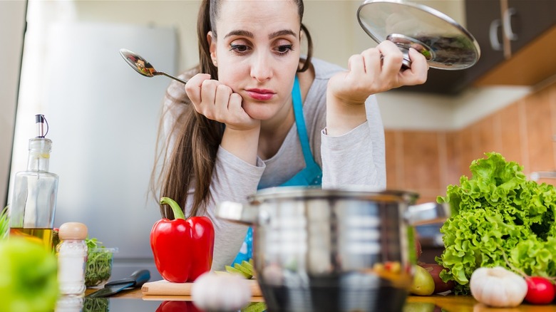 woman staring helplessly in the kitchen