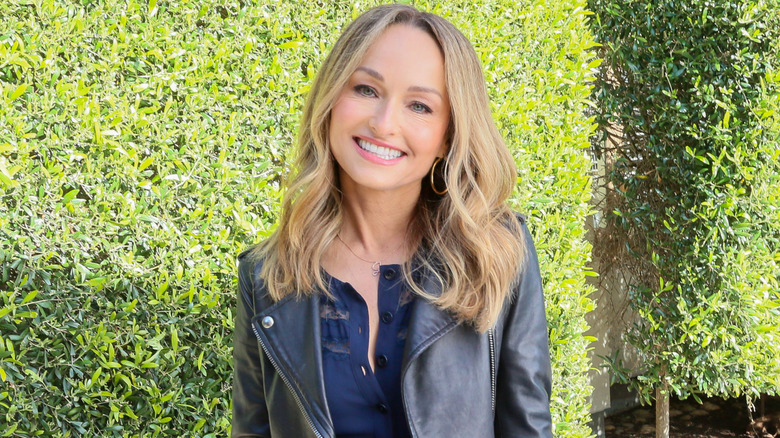 Giada De Laurentiis poses at a book signing table.