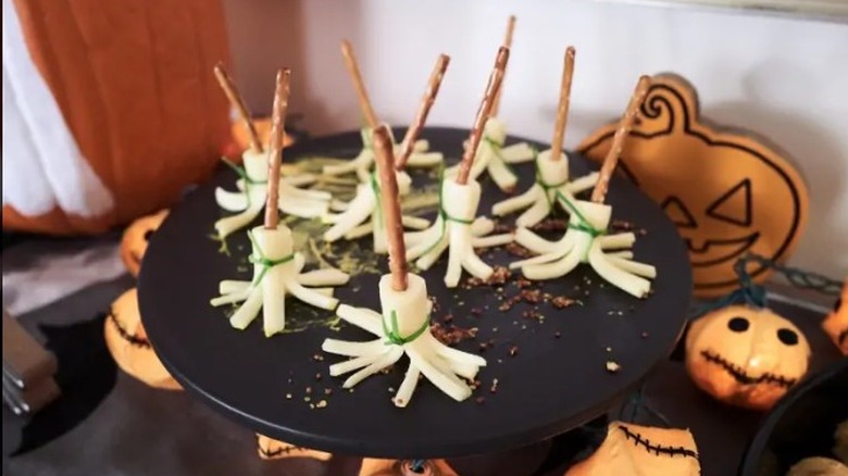 String cheese and pretzel sticks that look like witches broomsticks