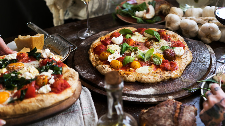 Rustic Italian pizzas with fresh toppings on a restaurant table
