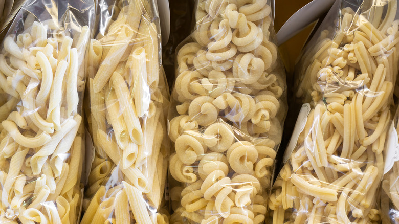 Plastic bags of dried pasta in various shapes.