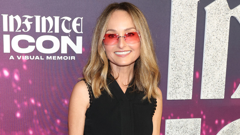Giada De Laurentiis smiling at red carpet event.