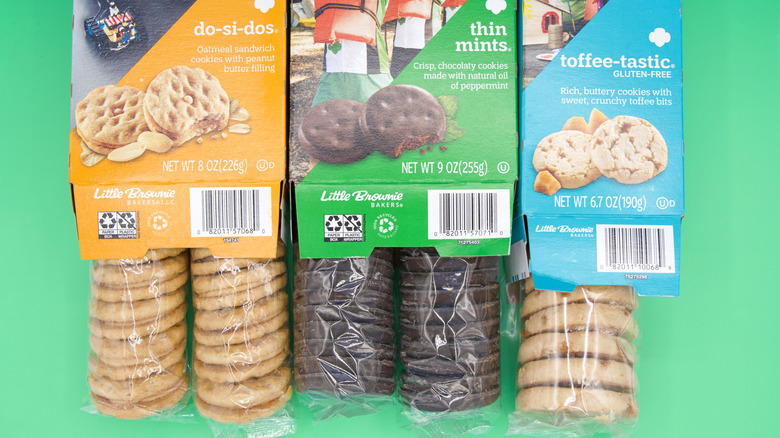Sleeves of Girl Scout cookies pulled halfway out of boxes