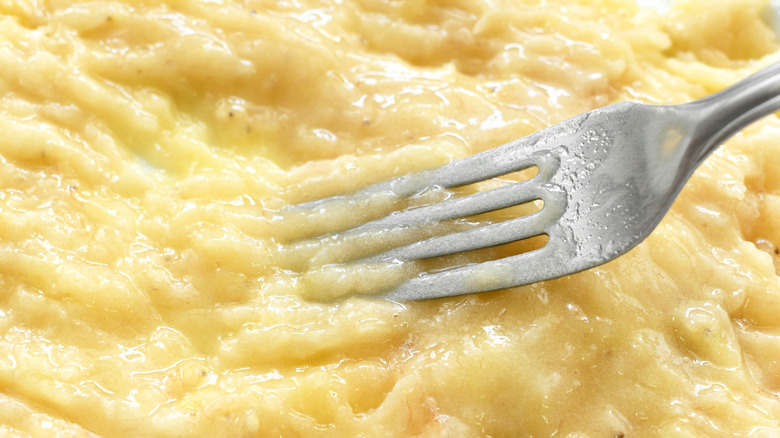 Fork mashing bananas