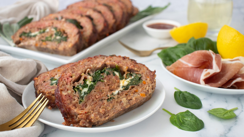 Slices of spinach-stuffed meatloaf on plate