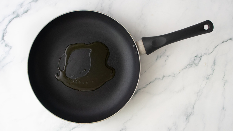 Drizzle of oil in skillet