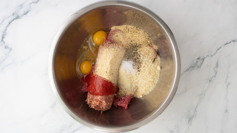 Eggs, ground meat, breadcrumbs, and seasonings in bowl