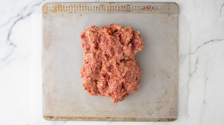 Meatloaf mixture sitting on sheet of wax paper