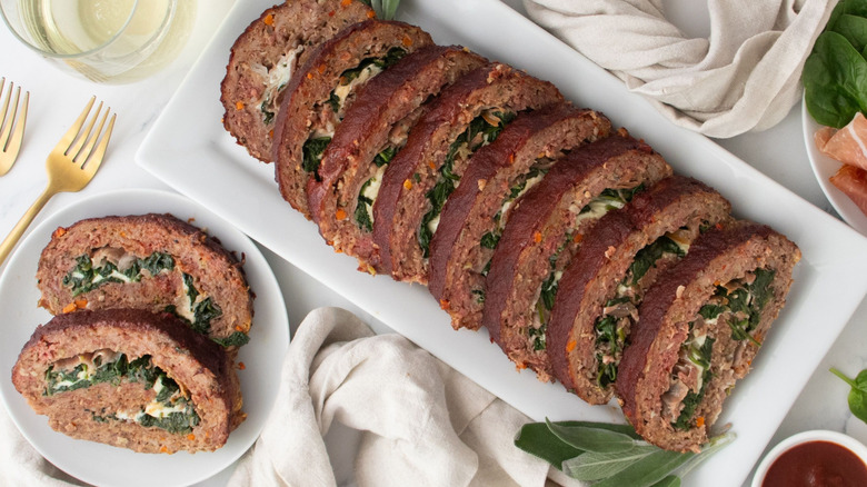 Slices of saltimbocca-inspired meatloaf on plate and serving platter