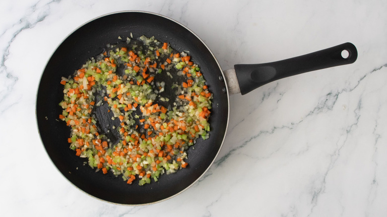 Sauteed mirepoix veggies in skillet